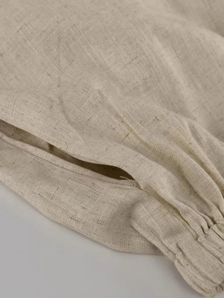 Beige fabric with a gold accent on a light gray background