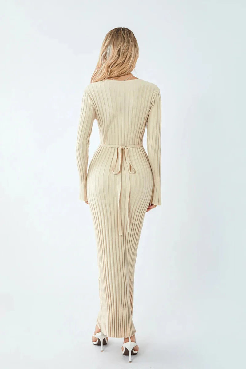 Woman wearing a beige ribbed dress on a white background