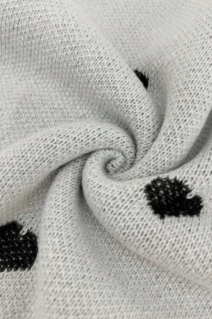 Close-up of gray fabric with black heart shapes