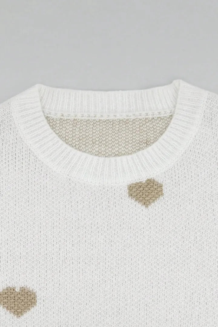 White sweater with brown heart patterns on a gray background