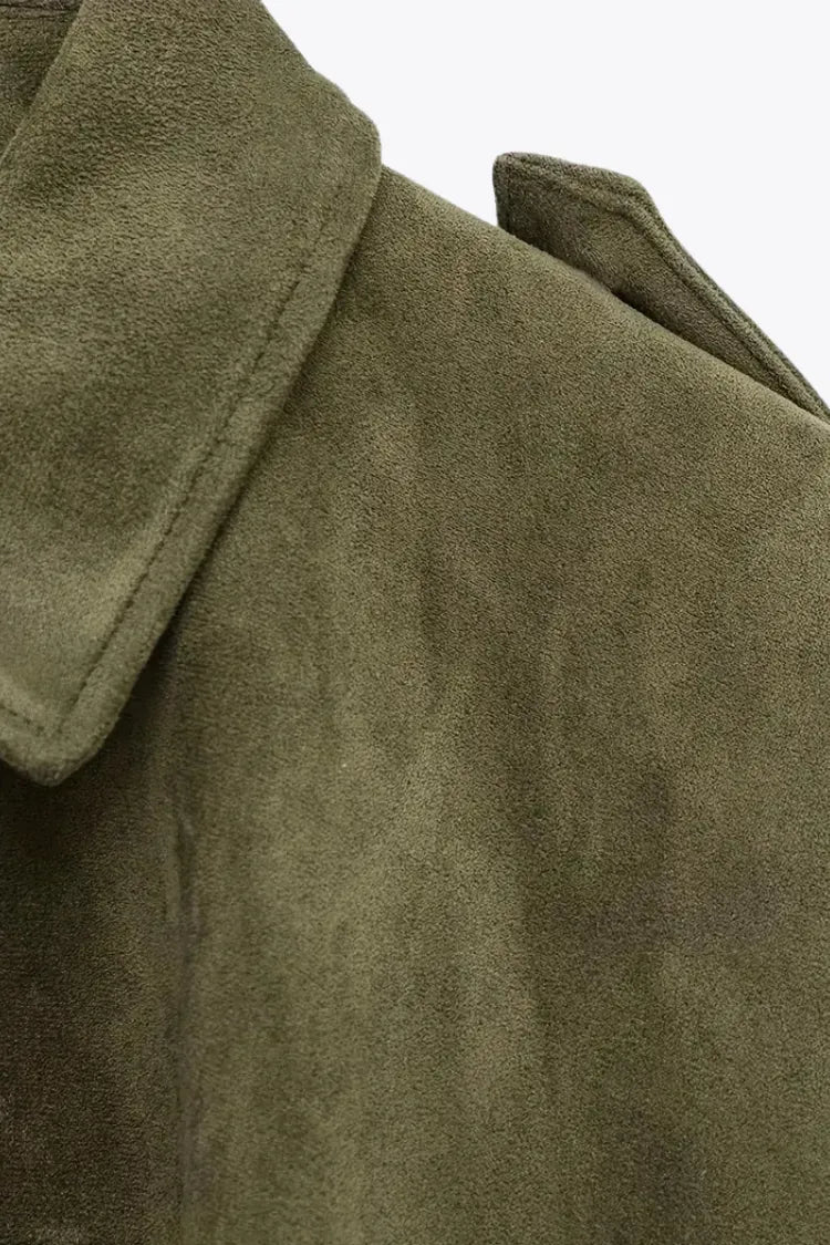 Close-up of a green suede coat with a collar on a white background