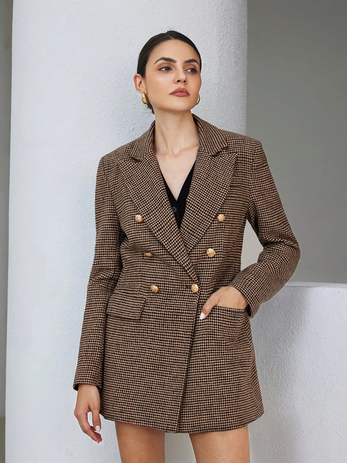 Woman wearing a brown checkered blazer over a black top against a neutral background