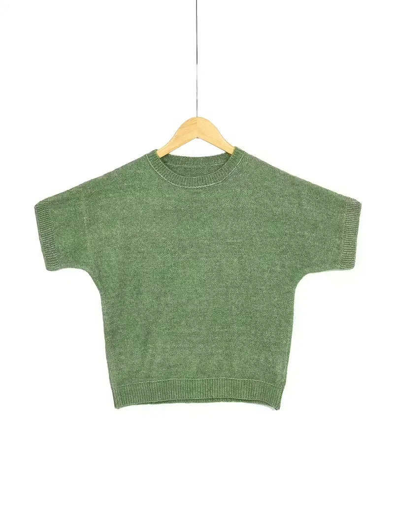 Green sweater on a wooden hanger against a white background