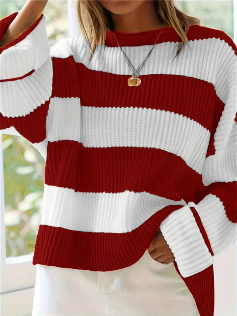 Red and white striped sweater worn by a person with a blurred background