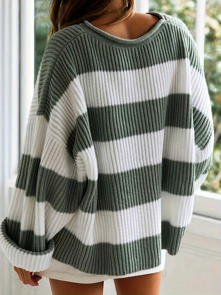 Green and white striped sweater worn by a person indoors.