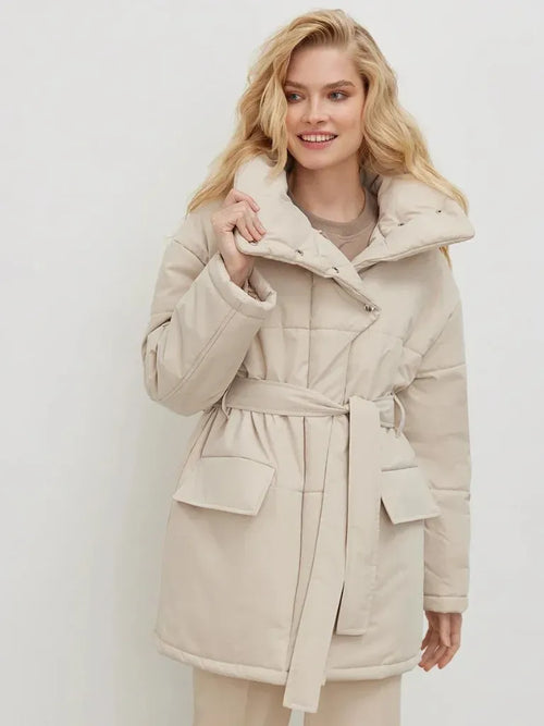 Woman wearing a beige coat against a white background