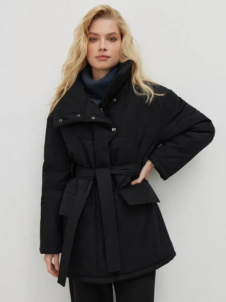 Woman wearing a black coat with a white background