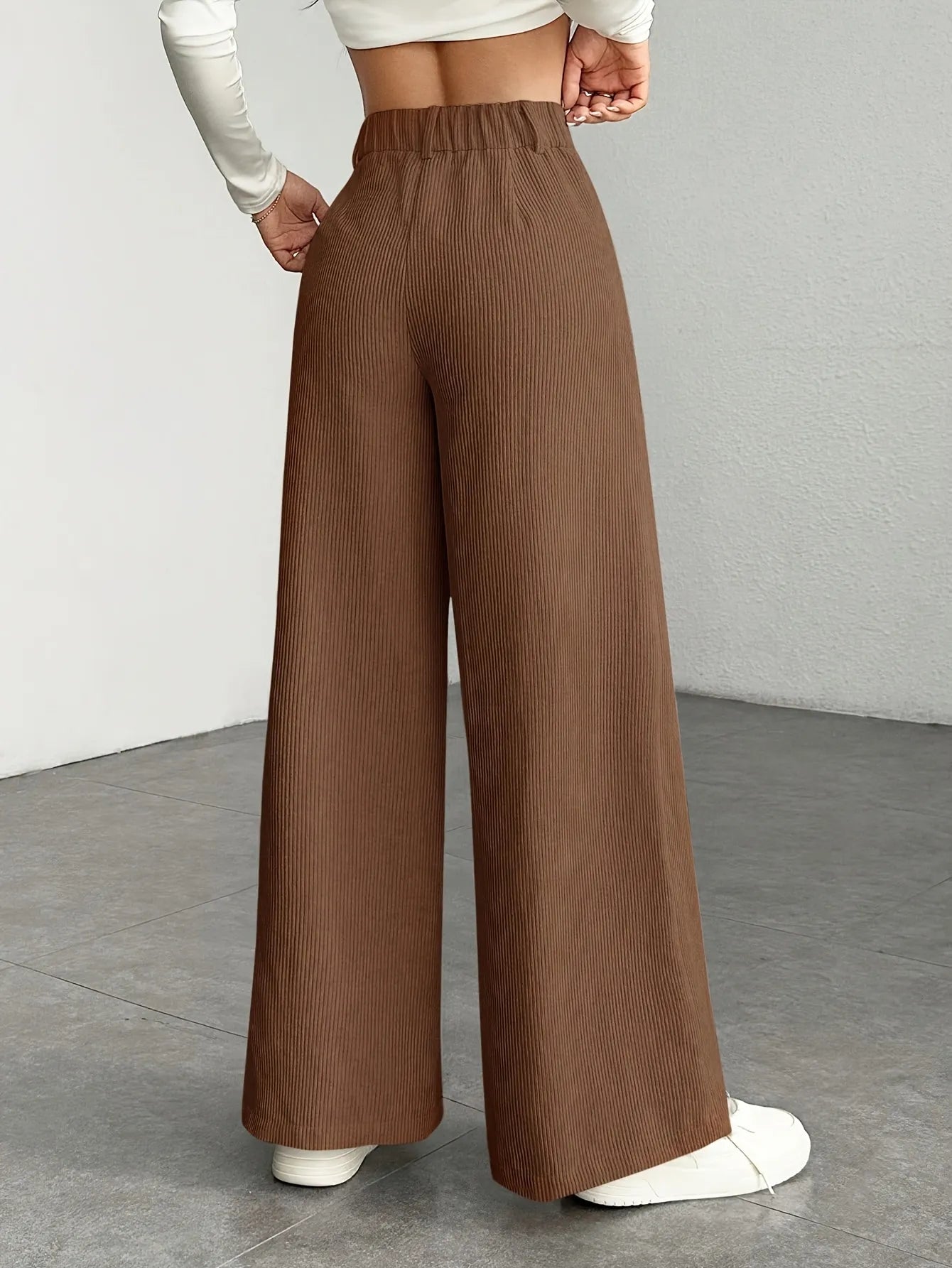 Brown wide-leg pants worn by a person on a plain background