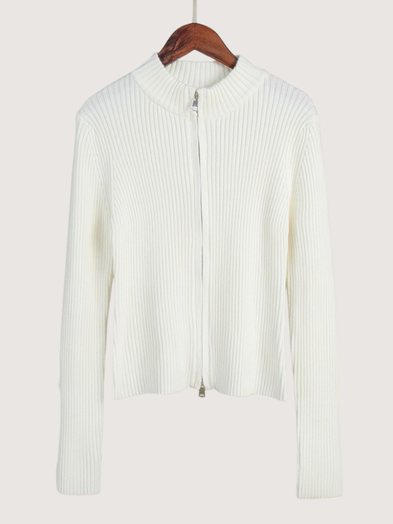 White ribbed knit sweater on a hanger against a white background
