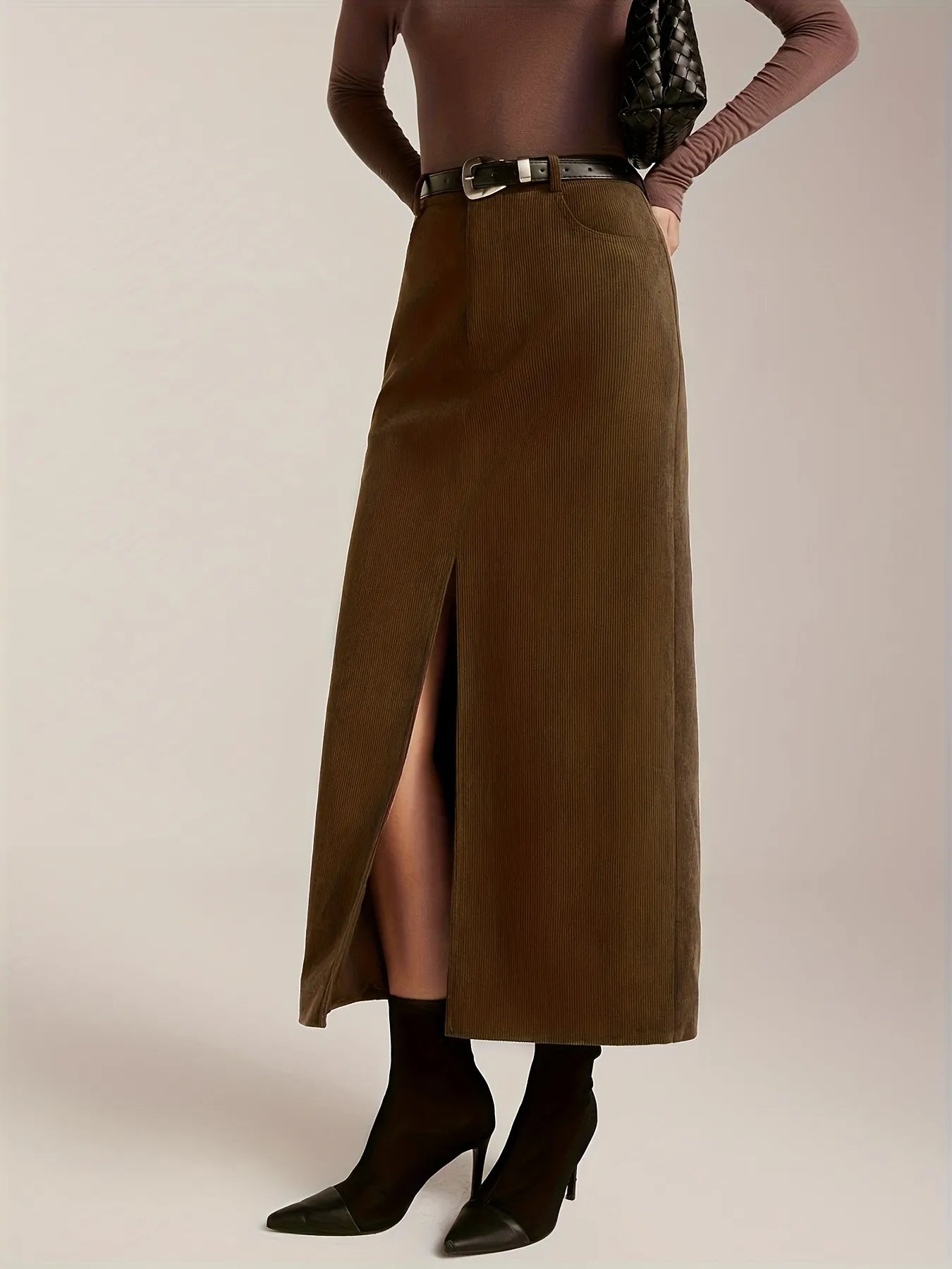 Brown long skirt worn by a person on a plain background