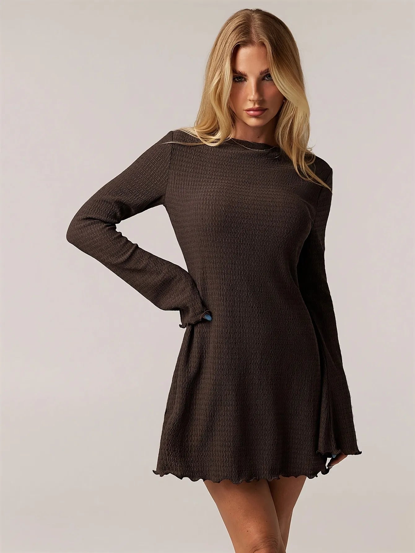 brown ribbed knit long-sleeve mini dress with flared sleeves and round neckline, fitted through the torso, casual yet elegant style