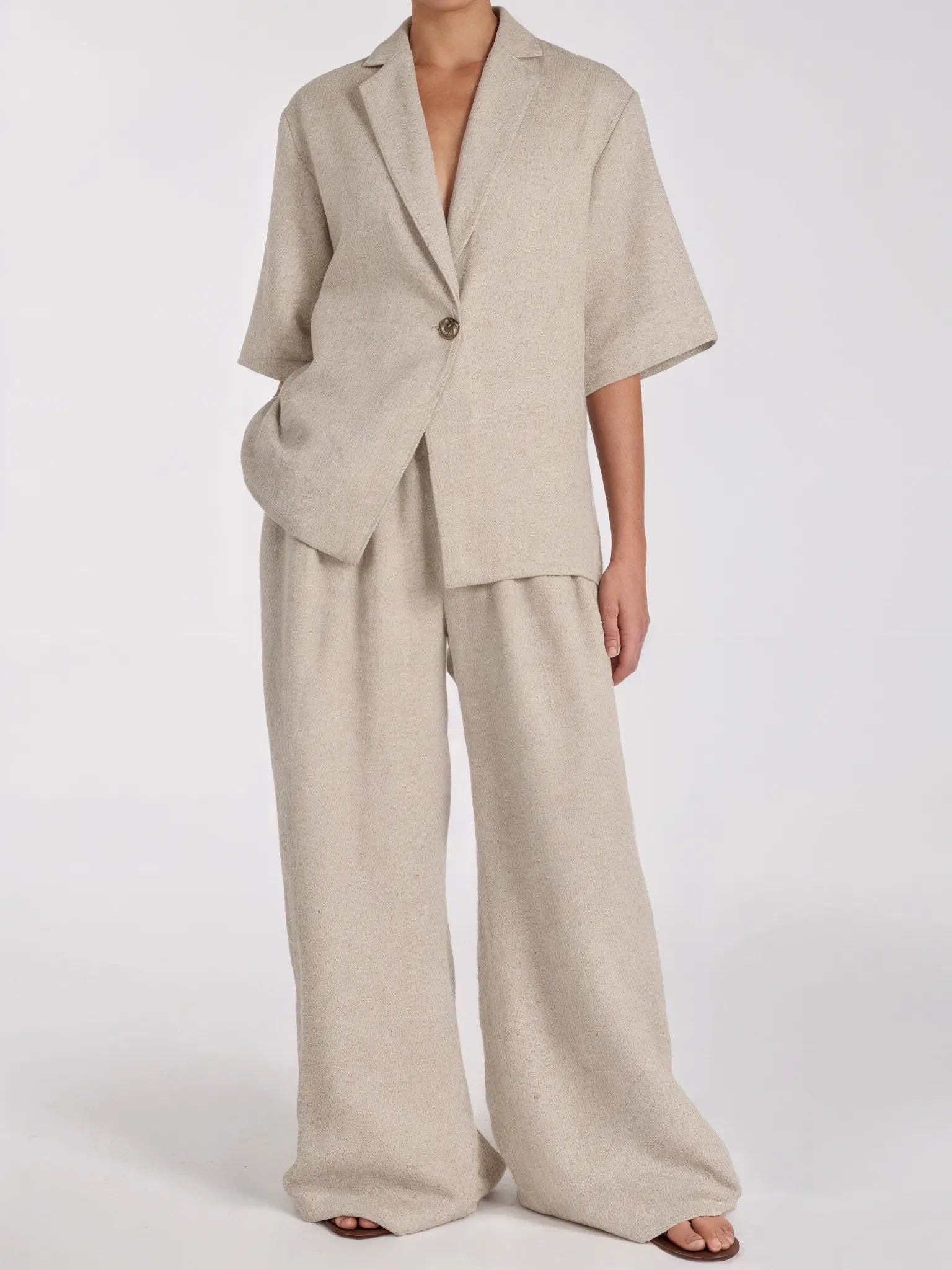 Beige suit with wide-leg pants on a white background