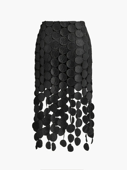 Black skirt with circular patterns and fringe on a white background