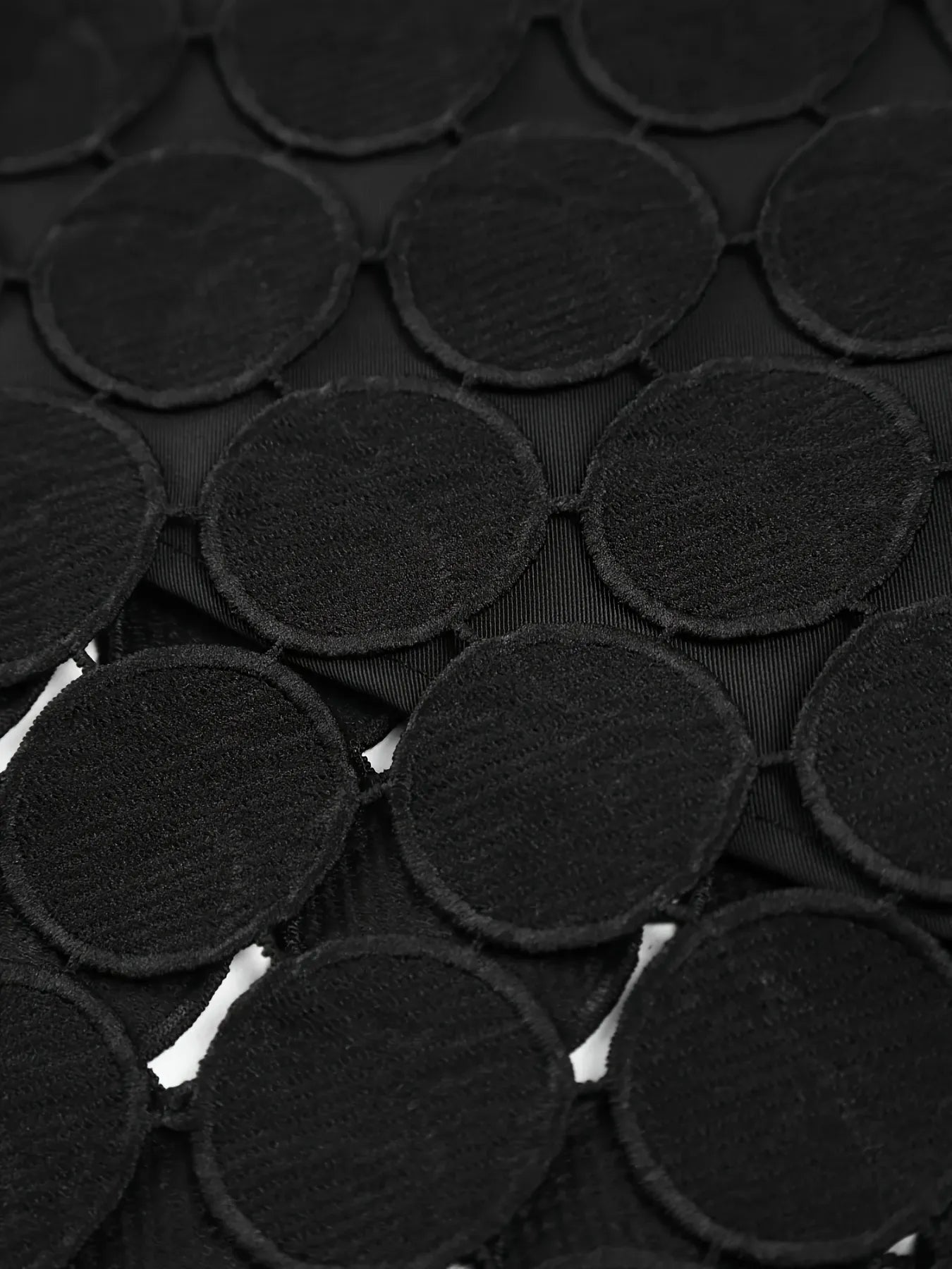 Close-up of black circular fabric patches