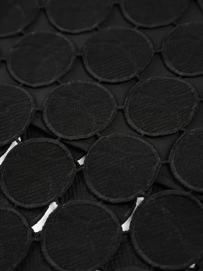 Close-up of black circular fabric patches