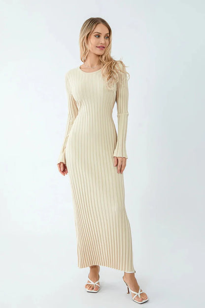 Woman wearing a beige ribbed dress on a white background