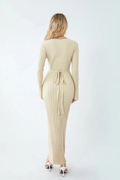 Woman wearing a beige ribbed dress on a white background