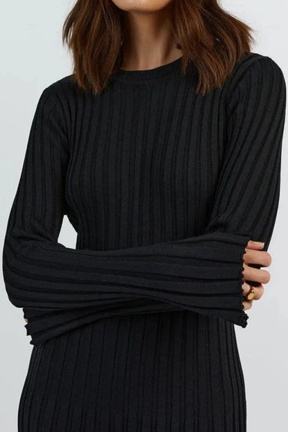 Black ribbed dress worn by a person on a white background