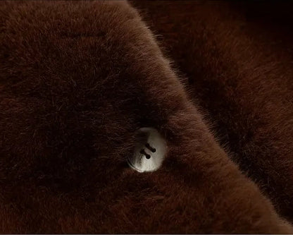 Close-up of brown fabric with a button on a dark background