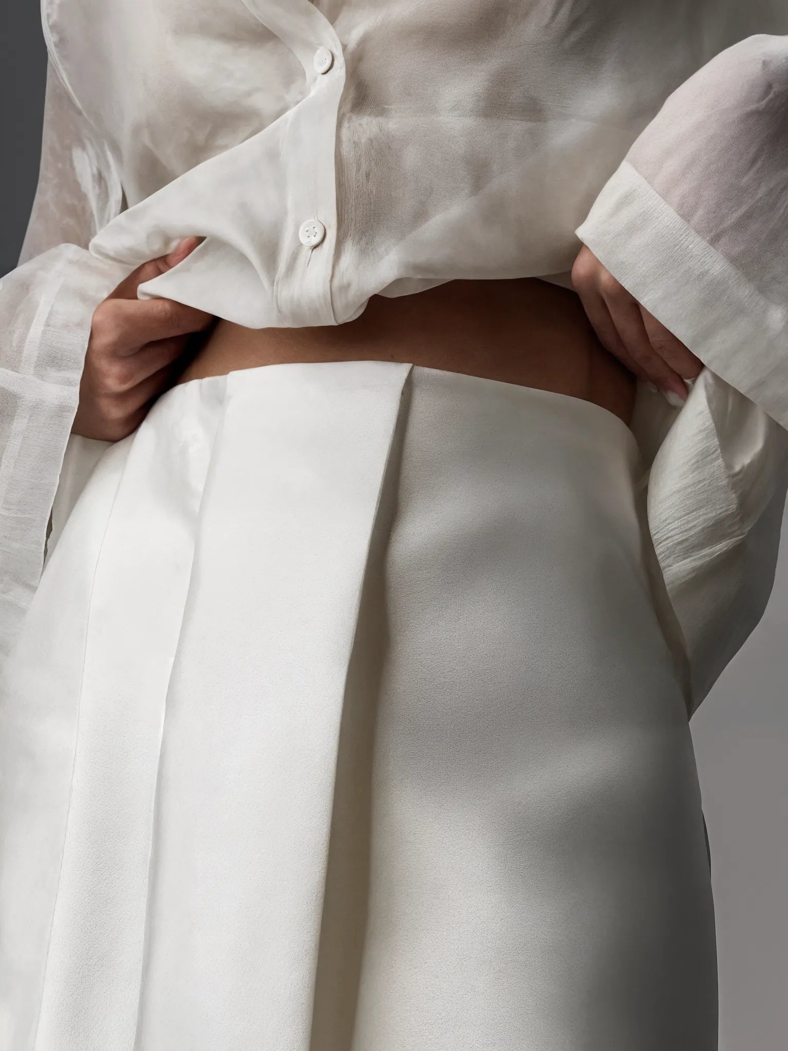 White shirt and pants with a neutral background