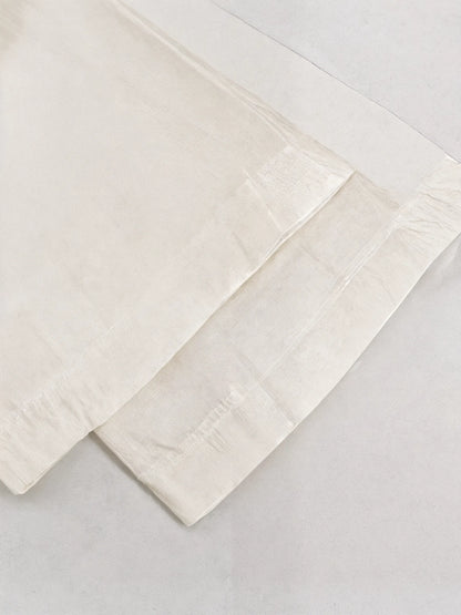 Two beige folded towels on a light gray background