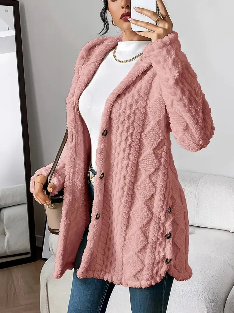 Person wearing a pink textured cardigan taking a mirror selfie.