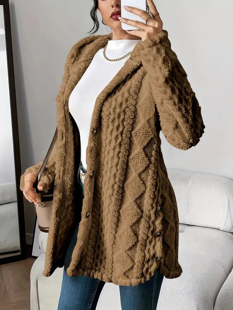 Person wearing a brown textured coat indoors