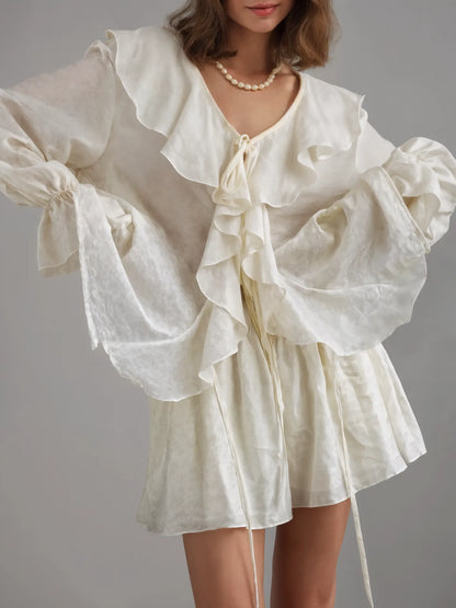 White ruffled blouse with a gray background