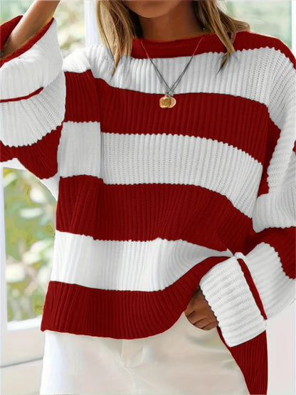 Red and white striped sweater worn by a person with a blurred background