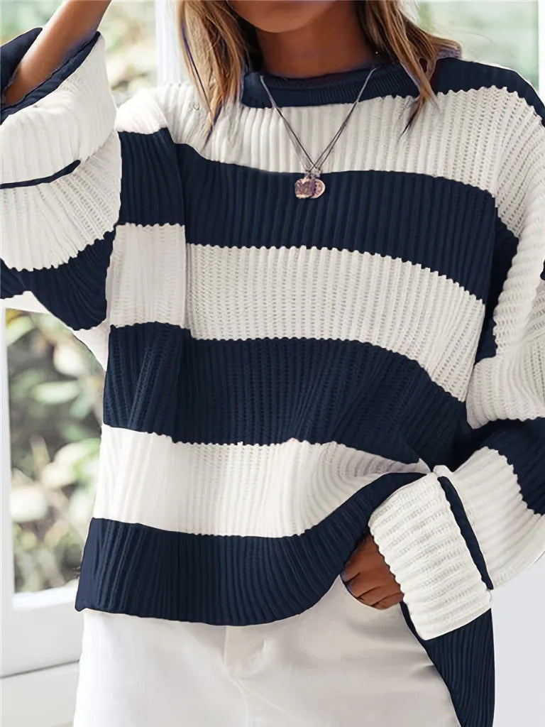 Person wearing a navy and white striped sweater with blurred background