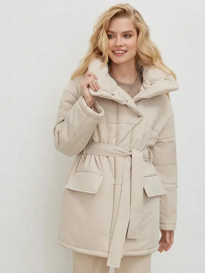 Woman wearing a beige coat against a white background