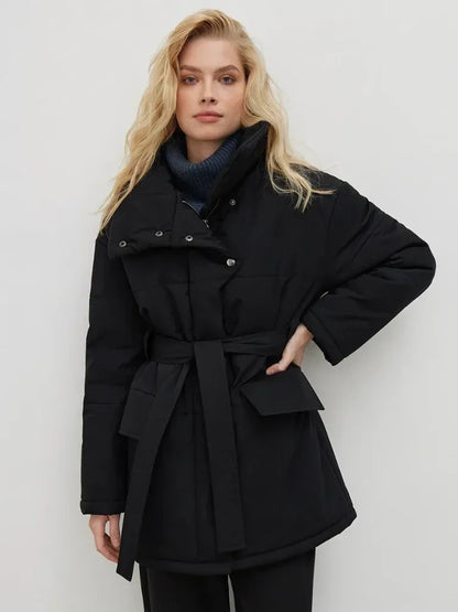 Woman wearing a black coat with a white background