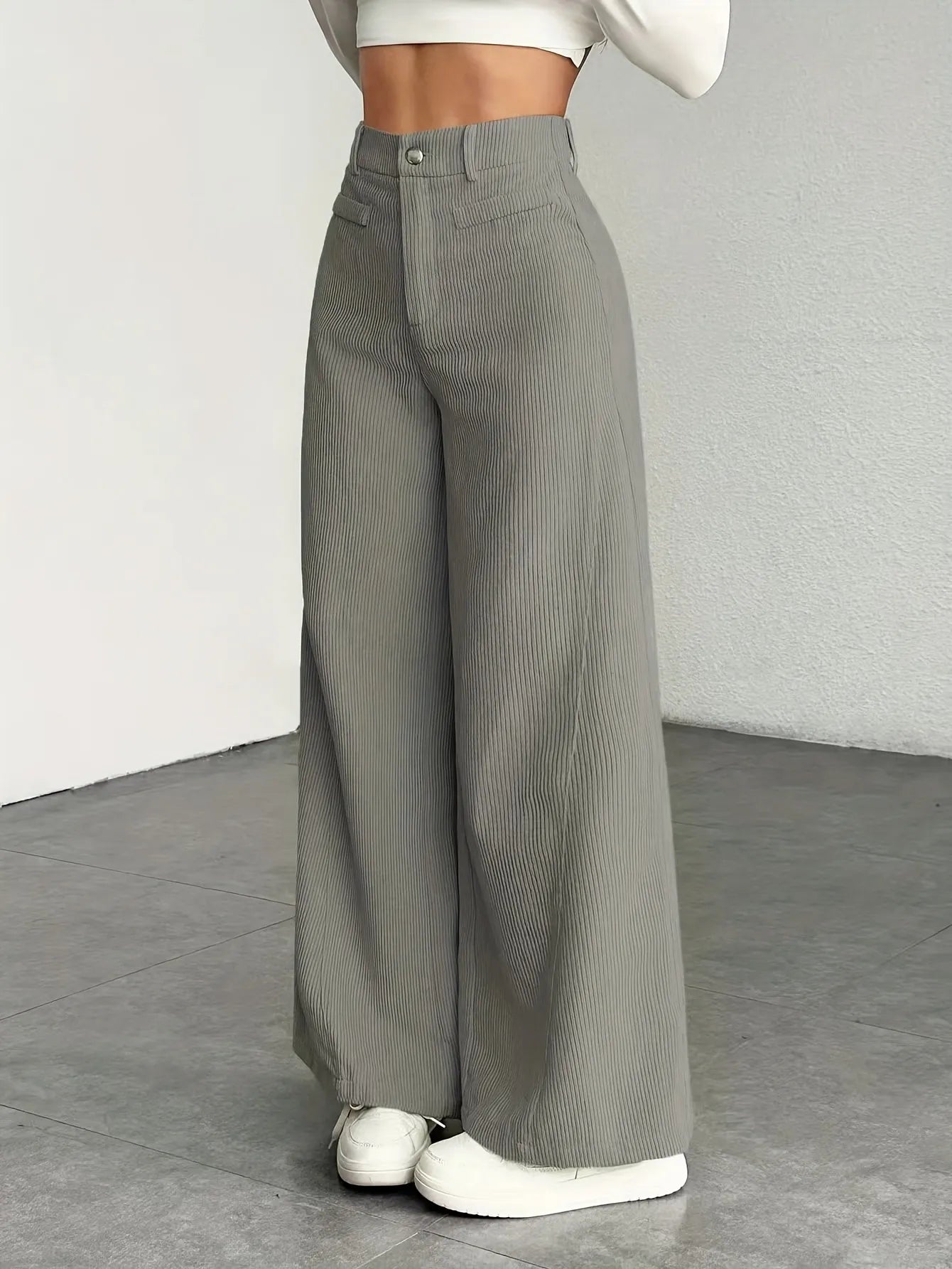 Gray wide-leg pants worn by a person on a plain background