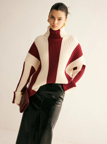Woman wearing a two-tone sweater with a plain background