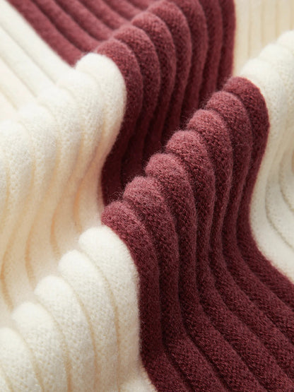 Close-up of ribbed yarn in white and burgundy colors.