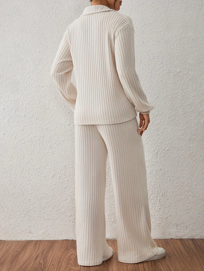 Person wearing a ribbed knit outfit against a white wall