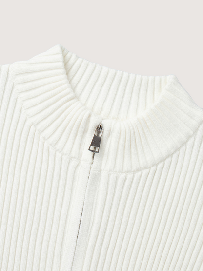 Close-up of a white ribbed sweater with a zipper on a light gray background