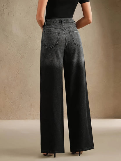 Person wearing black wide-leg jeans against a beige background