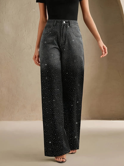 Person wearing black jeans with star patterns on a beige background