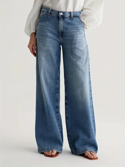 Person wearing blue wide-leg jeans on a white background