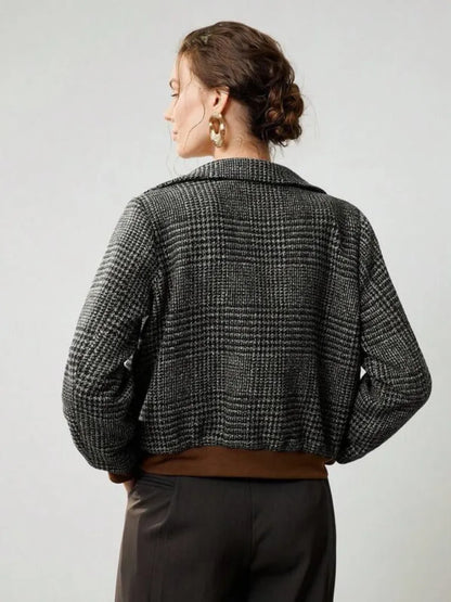 Person wearing a checkered jacket on a plain background