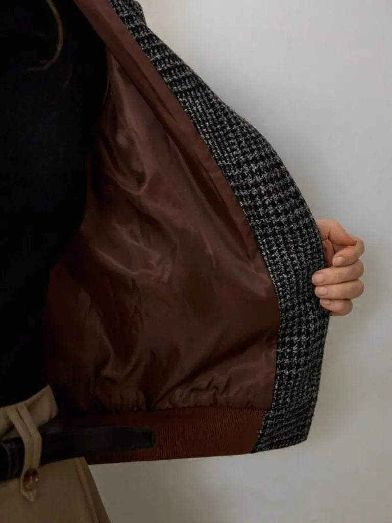 Close-up of a brown and black textured jacket with a white background